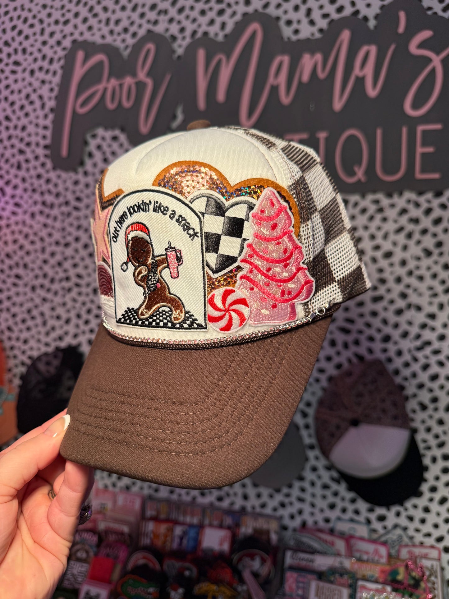 Brown and white checkered out here looking like a snack, gingerbread Christmas trucker hat