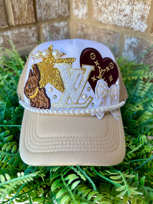 A lil boujee tan and white Lv trucker hat