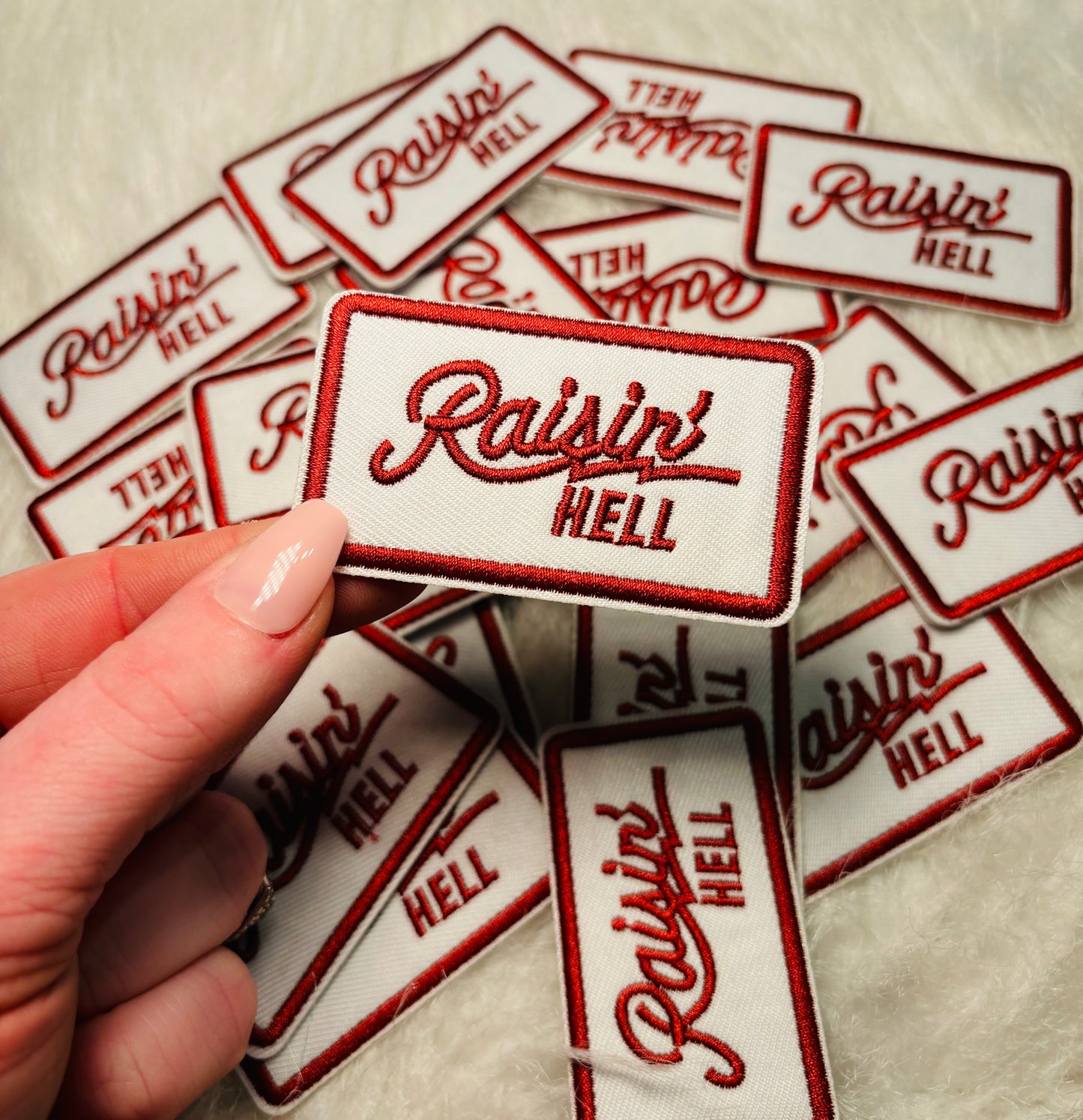 Raisin Hell embroidered iron on trucker hat patch