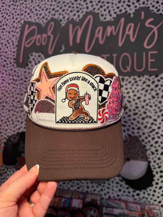 Brown and white checkered out here looking like a snack, gingerbread Christmas trucker hat